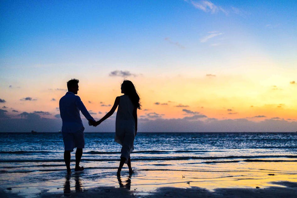American retiree couple walking on the beach in San Jose del Cabo