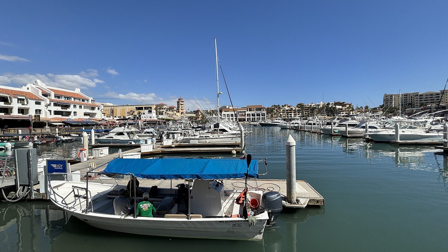 Luxury yachts docked at Cabo San Lucas Marina with restaurants and nightlife nearby
