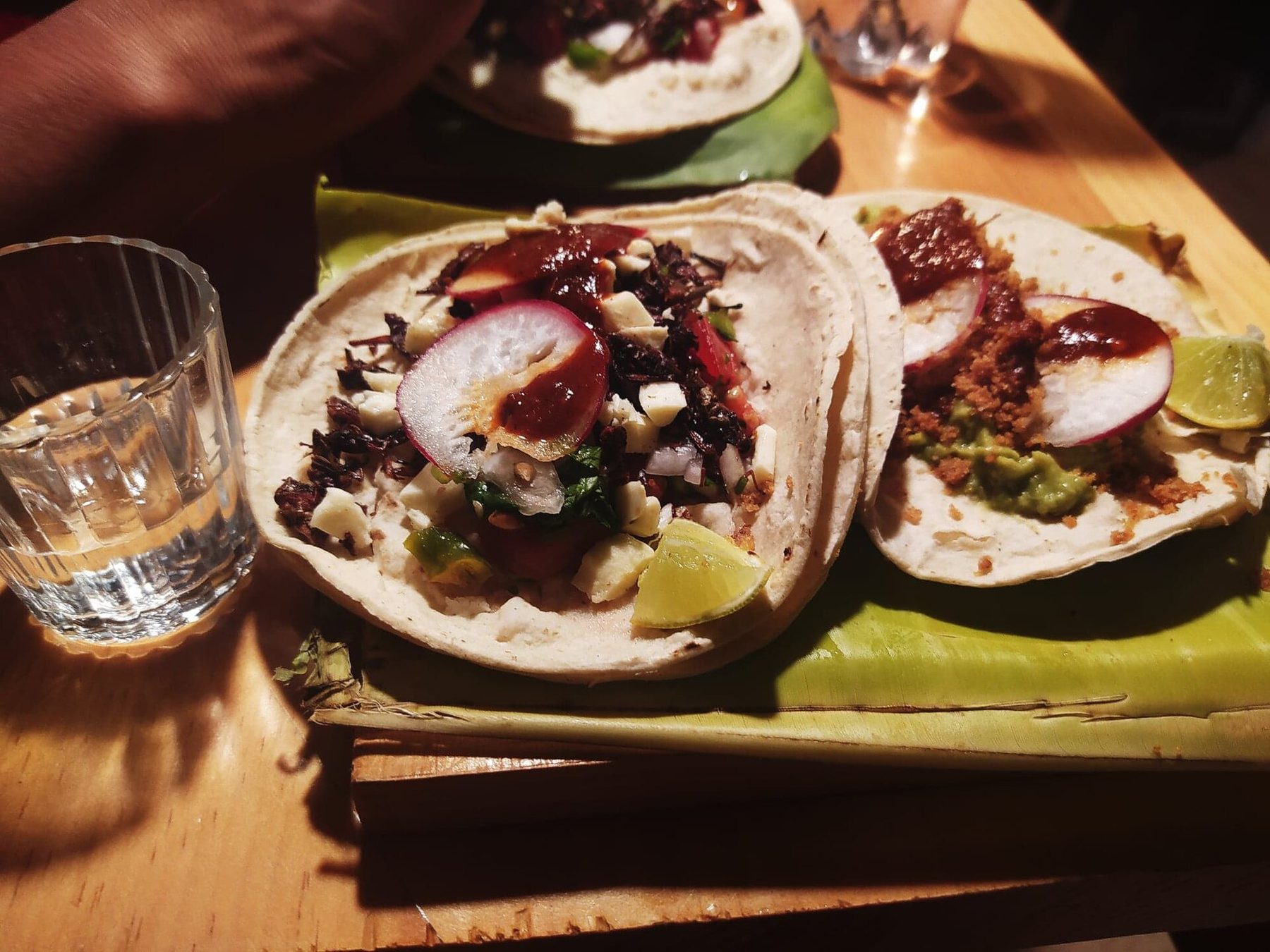 A mezcal tasting flight served with chapulines tacos