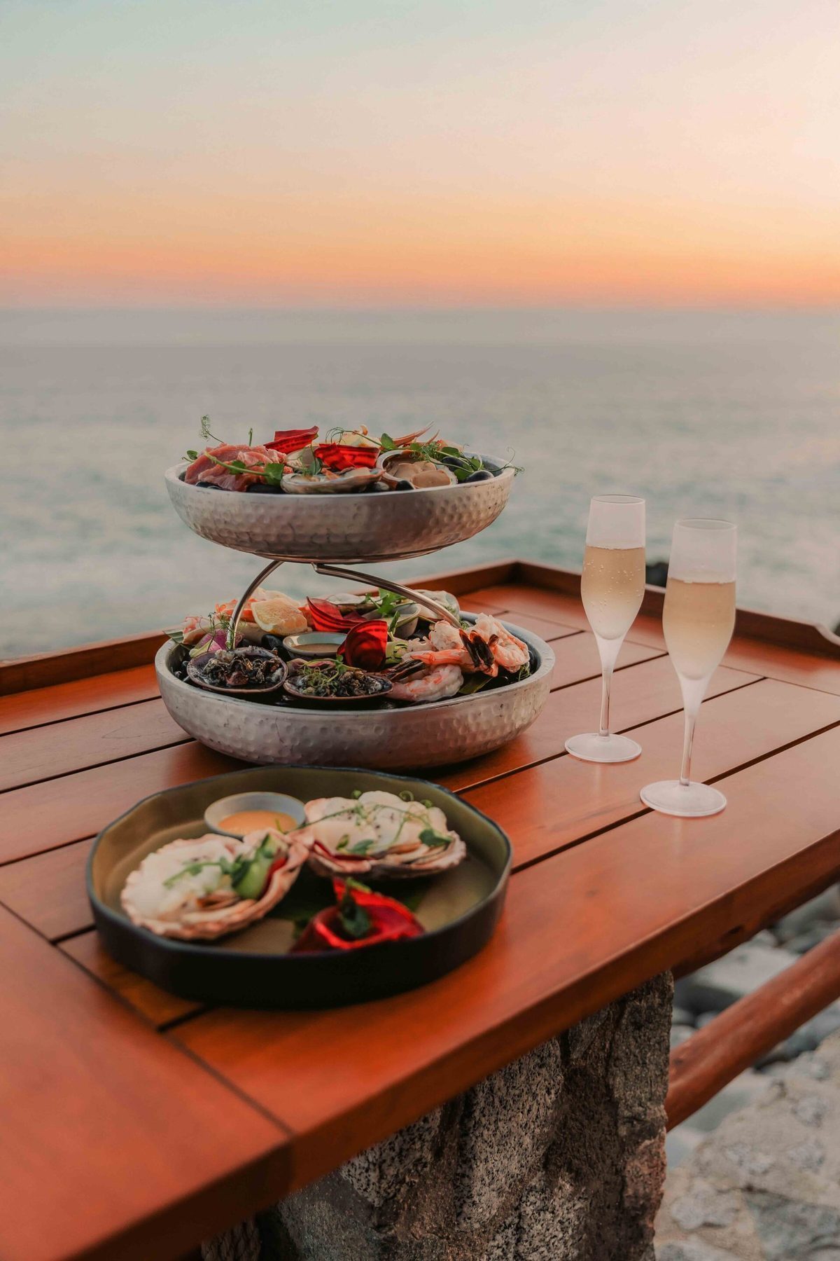 Pacific Ocean cliffs at Pedregal de Cabo San Lucas with dramatic sunset over the water