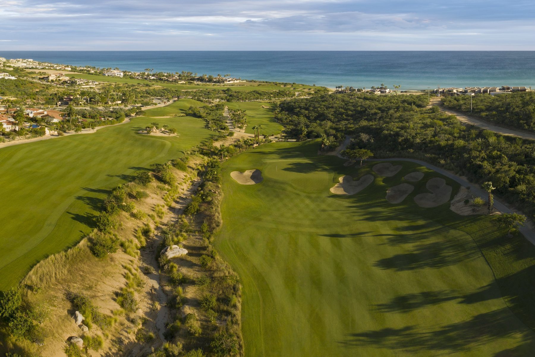 Puerto Los Cabos master-planned community aerial view with golf courses and ocean
