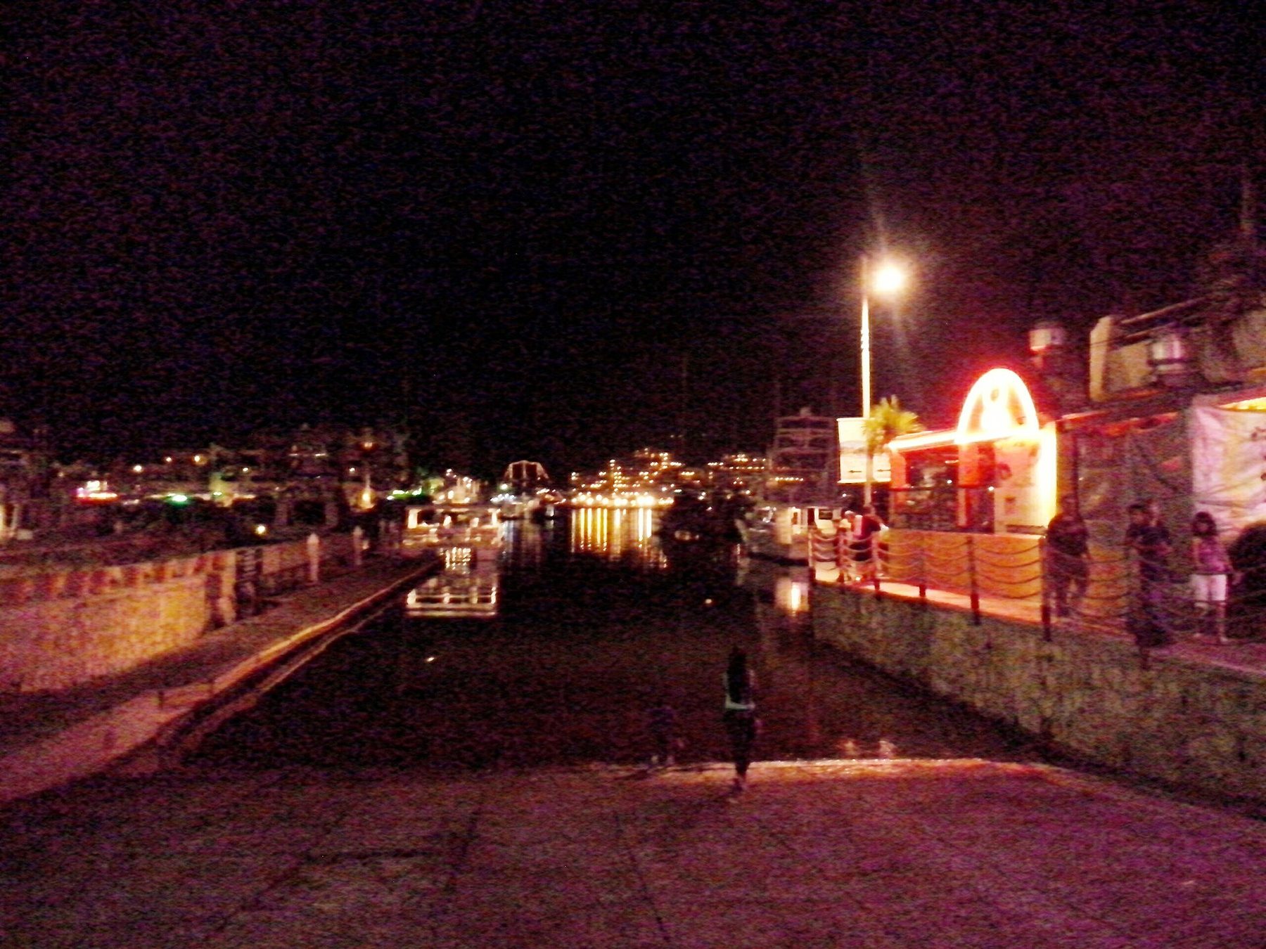 Marina Cabo San Lucas with boats at their slips after dark